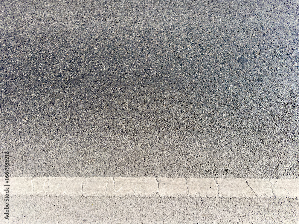 Fototapeta premium Asphalt road surface with old white line, high angle view