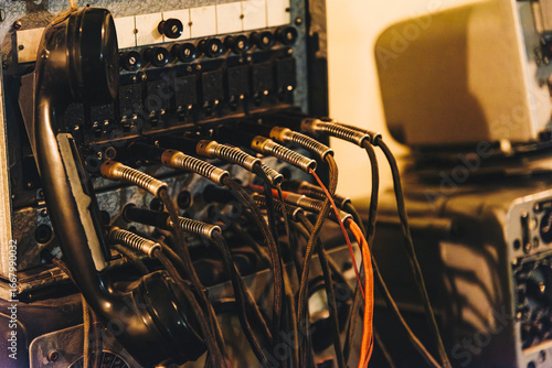 Vintage telephone switchboard with cables and handset