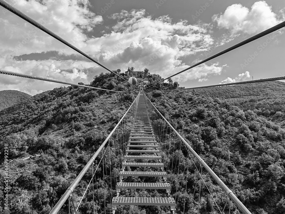 Fototapeta premium Sellano, Italy - August 24, 2025, first-person view from a section of the new 175-meter-high Tibetan bridge, the highest in Europe, connecting the Italian municipality of Sellano to Montesanto Castle.