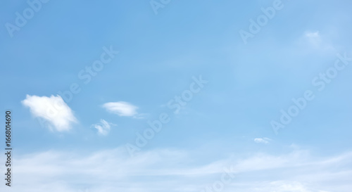 A serene and tranquil pale blue sky with a few wispy, soft white clouds. The minimalist composition and gentle colors create a peaceful backdrop, ideal for concepts of calm, relaxation, and purity.