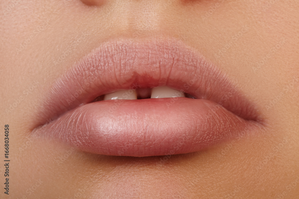 Fototapeta premium Close-up of full female lips with natural pink makeup. Teeth with charming gap. Skincare and cosmetic. Dental care, orthodontics, healthcare, cosmetic dentistry and wellness industry promotions