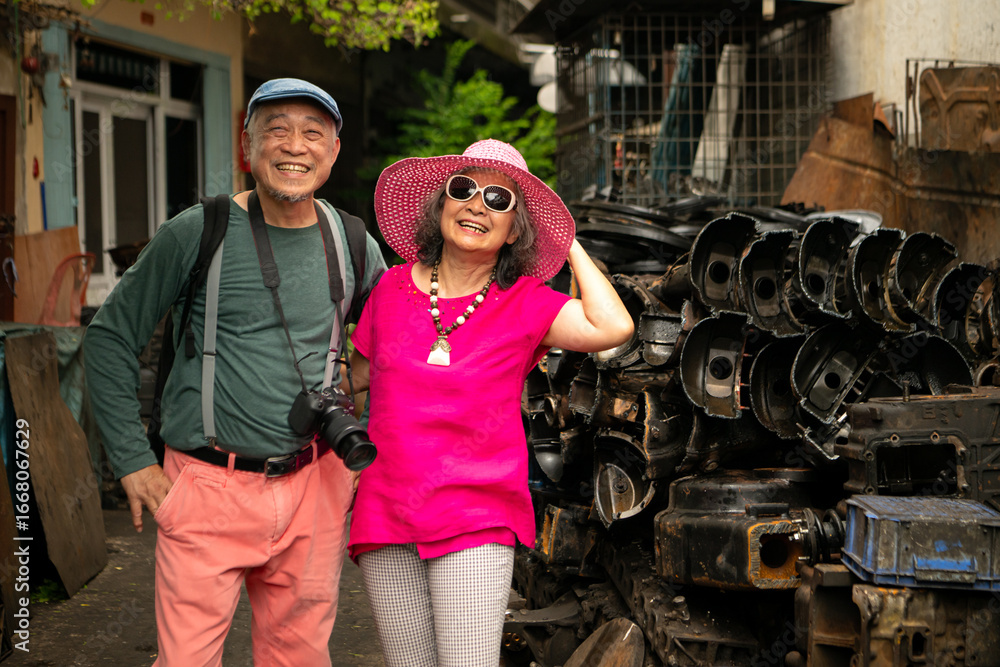 Obraz premium A happy senior couple strolling along a city's old neighborhood, enjoying travel
