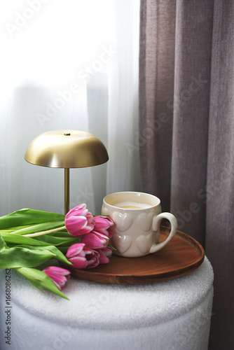 Cup with cappuccino, spring flowers tulips, morning concept, woman's day, bedroom design, gold modern desk lamp