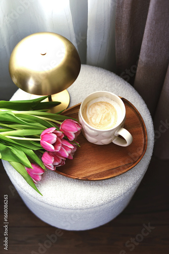 Cup with cappuccino, spring flowers tulips, morning concept, woman's day, bedroom design, gold modern desk lamp