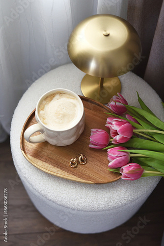 Cup with cappuccino, spring flowers tulips, morning concept, woman's day, bedroom design, gold modern desk lamp
