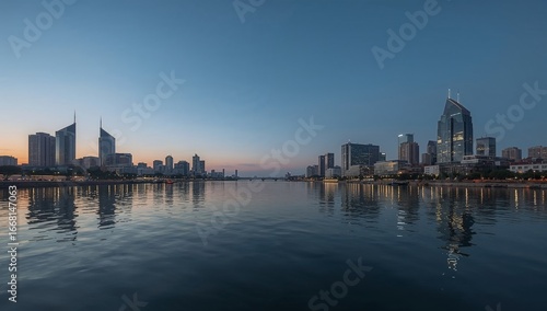 Modern City Skyline at Sunset Over Water