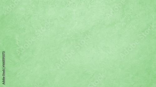 A light sea green painted concrete wall texture with a rough, subtle pattern. This neutral background offers a minimalist and modern aesthetic for various digital projects.