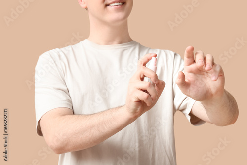 Young man with sanitizer on...