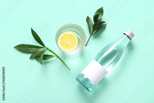 Bottle of water, glass with...