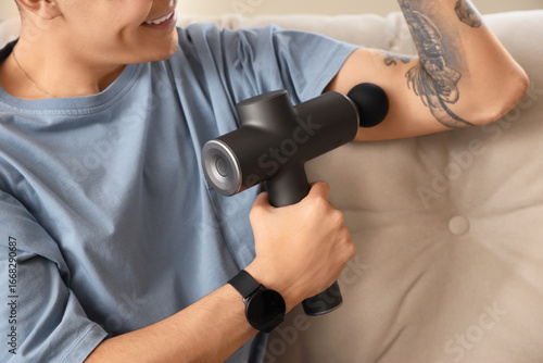 Young man massaging his arm...