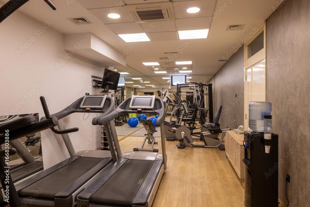 Fototapeta premium Modern fitness gym with equipment and mirrors
