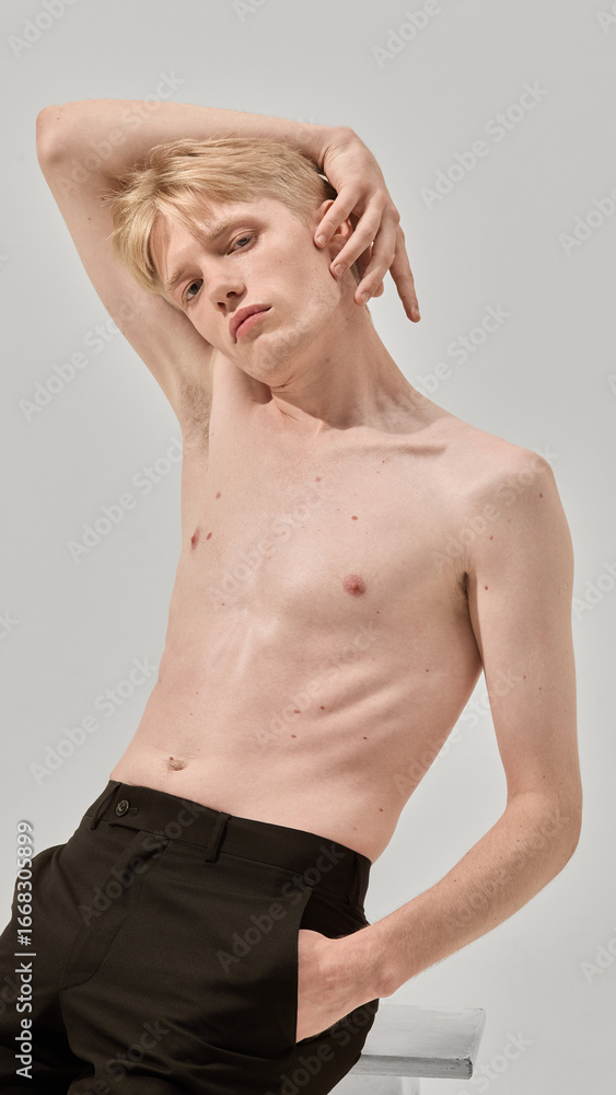 Obraz premium Shirtless man posing with artistic body gesture skincare style. Concept of fashion, wellness media, barber branding, lifestyle editorial, packaging design, and beauty culture for men.
