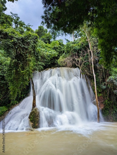 heavy water at Kuang Si Waterfall Cascading Through Lush Jungle in Luang Prabang, Laos – Tropical Nature Escape