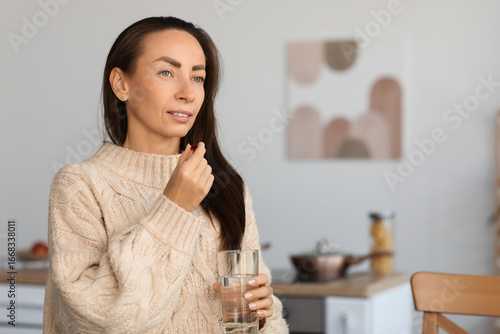 Beautiful woman taking medi...
