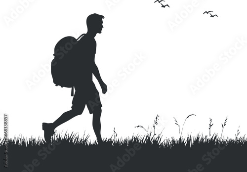 Silhouette of a man hiking with a backpack walking through grassy field with birds flying overhead