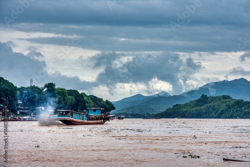 Stormy Skies Over Mekong River Cruise in Luang Prabang, Laos – Dramatic Weather and Jun