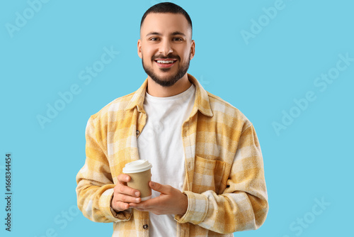 Young man holding paper cup...