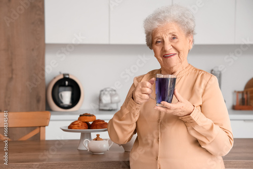 Happy senior woman with gla...