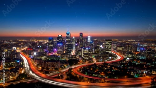 A stunning twilight view of Philadelphia's skyline with illuminated buildings and highways
