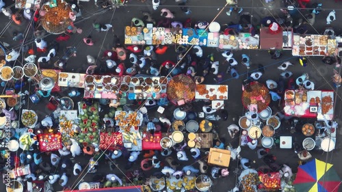 Dhaka, Bangladesh - 23 August 2025: Aerial view of bustling food stalls create a vibrant tapestry of colors amidst the throng of people.