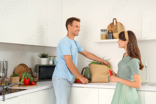 Young couple with paper bag...