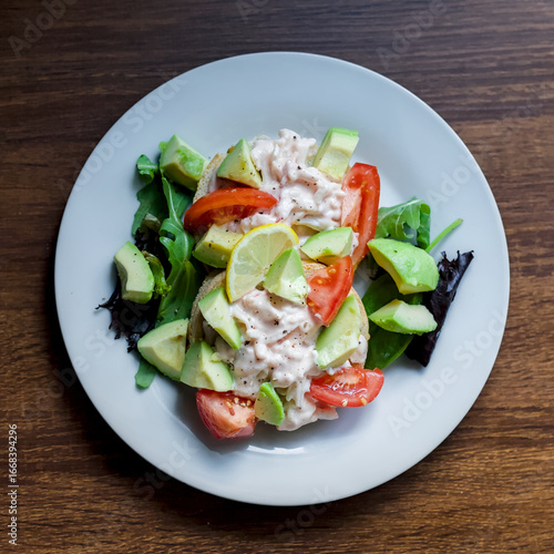 Top Down View of Surimi Pollock and Prawns Tangy Seafood Sauce Salad on Toast with Avocado and Tomato