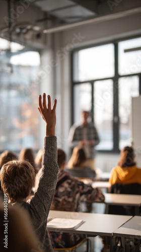 A student raises their hand to ask a question in a classroom setting.
