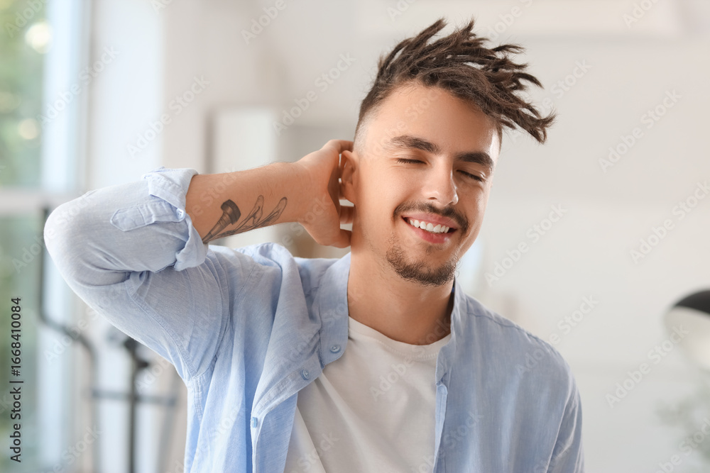 Obraz premium Portrait of young man with dreadlocks at home