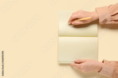 Female hands writing in not...