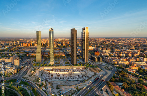 Aerial view of the Cuatro Torres Business Area skyscrapers in Madrid, Spain, at sunset