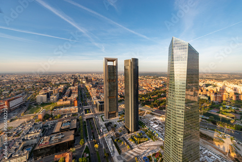 Aerial view of the Cuatro Torres Business Area skyscrapers in Madrid, Spain, at sunset