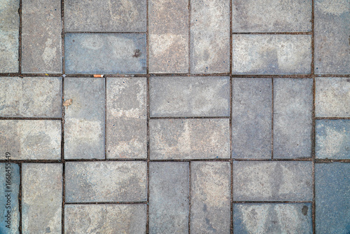 Wallpaper Mural A textured gray paving stone pattern makes a versatile backdrop. Irregular shapes and slight color variations provide subtle visual interest suitable for various design applications. Torontodigital.ca