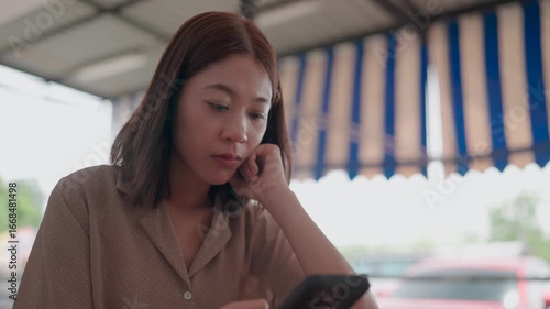 A pensive individual gazes at a smartphone lost in contemplation. This shot captures the blend of introspection with modern technology.