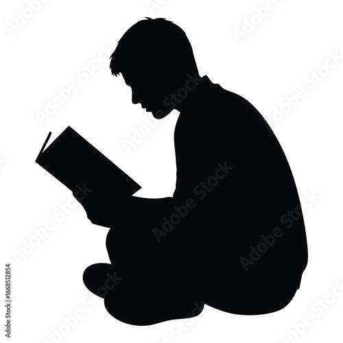 Silhouette of a young person sitting cross-legged engrossed in reading a book outdoors