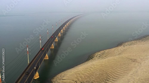Wallpaper Mural Sirajganj, Bangladesh - 23 August 2025: Aerial view of Bangabandhu bridge stretching across the water, flanked by rippled sandbanks under a misty sky. Torontodigital.ca