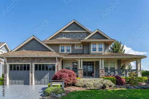 Two story stucco luxury house with nice spring blossom landscape in Vancouver, Canada, North America. Day time on May 2025.