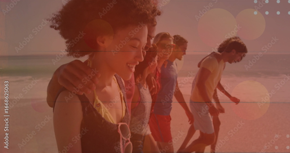 Fototapeta premium Walking seven friends in beachwear along beach shoreline at sunset, with sunglasses and lens flares