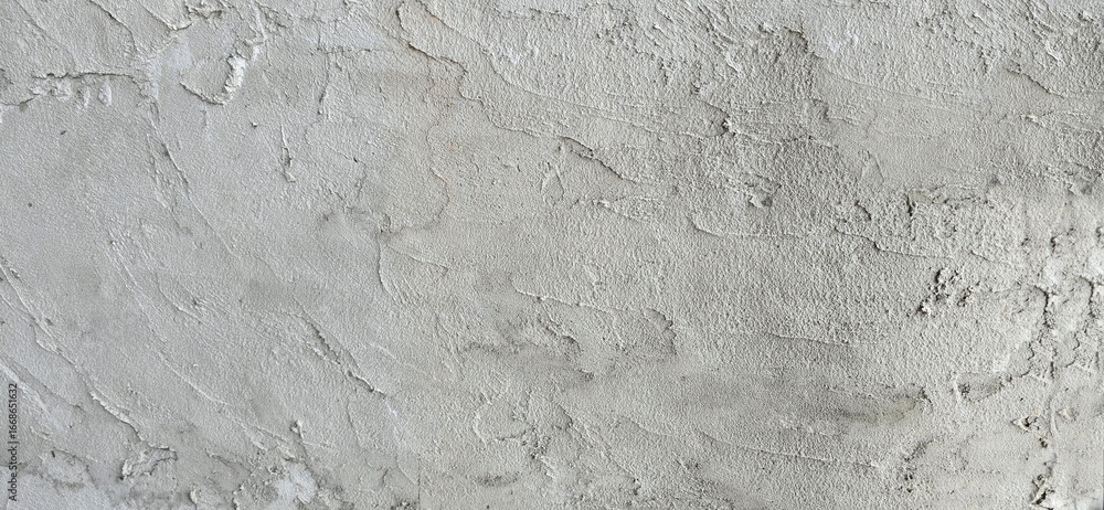 Uneven plastered cement walls or floors. Rough surfaces. Uneven plastering to create patterns or to prepare for tiling. Gray background. Untidy plastering. Plastering process is not yet complete.

