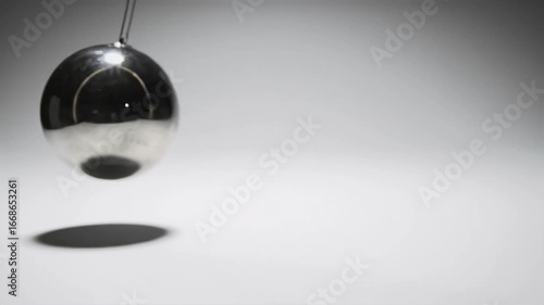 Swinging metallic egg pendulum motion physics experiment