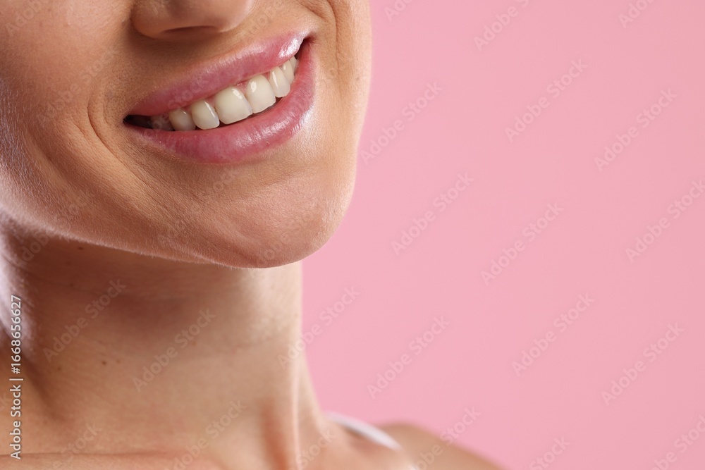 Fototapeta premium Woman with beautiful healthy teeth on pink background, closeup. Space for text