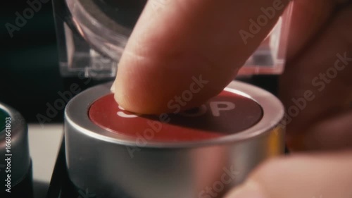 Pushing a Red Stop Button with a Safety Cover