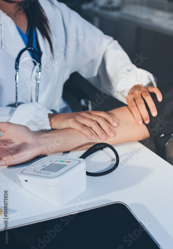 Doctor checking patient arterial blood pressure in hospital. Health care Concept