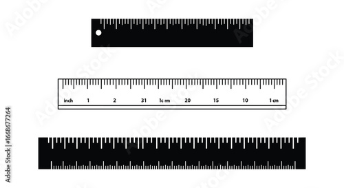 Three black and white rulers with measurements on a plain background
