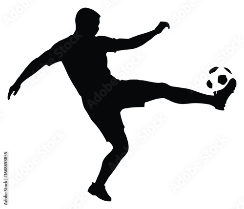 Silhouette of a football player kicking a ball