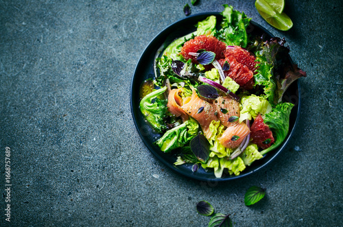 Gourmet salmon and grapefruit salad with herbs and parmesan-lemon dressing