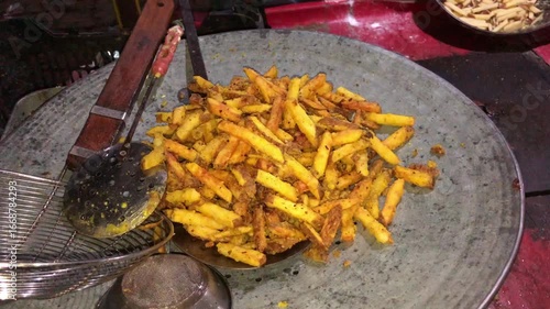 Spicy fried potatoes on plate