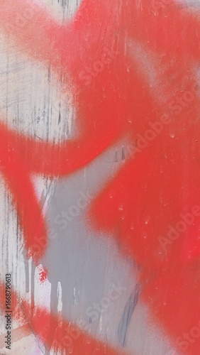 Spray paint graffiti details close-up on an old metal surface, abstract background