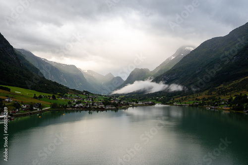 Norway villages in fjord on near olden. Cloudy Nordic day.