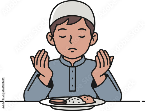 A young Muslim boy in a grey tunic and white kufi cap, praying with hands raised before eating.
