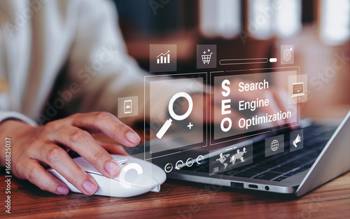 Fotografija Businesswoman using a laptop for analysis SEO icon to analyze search engine opti